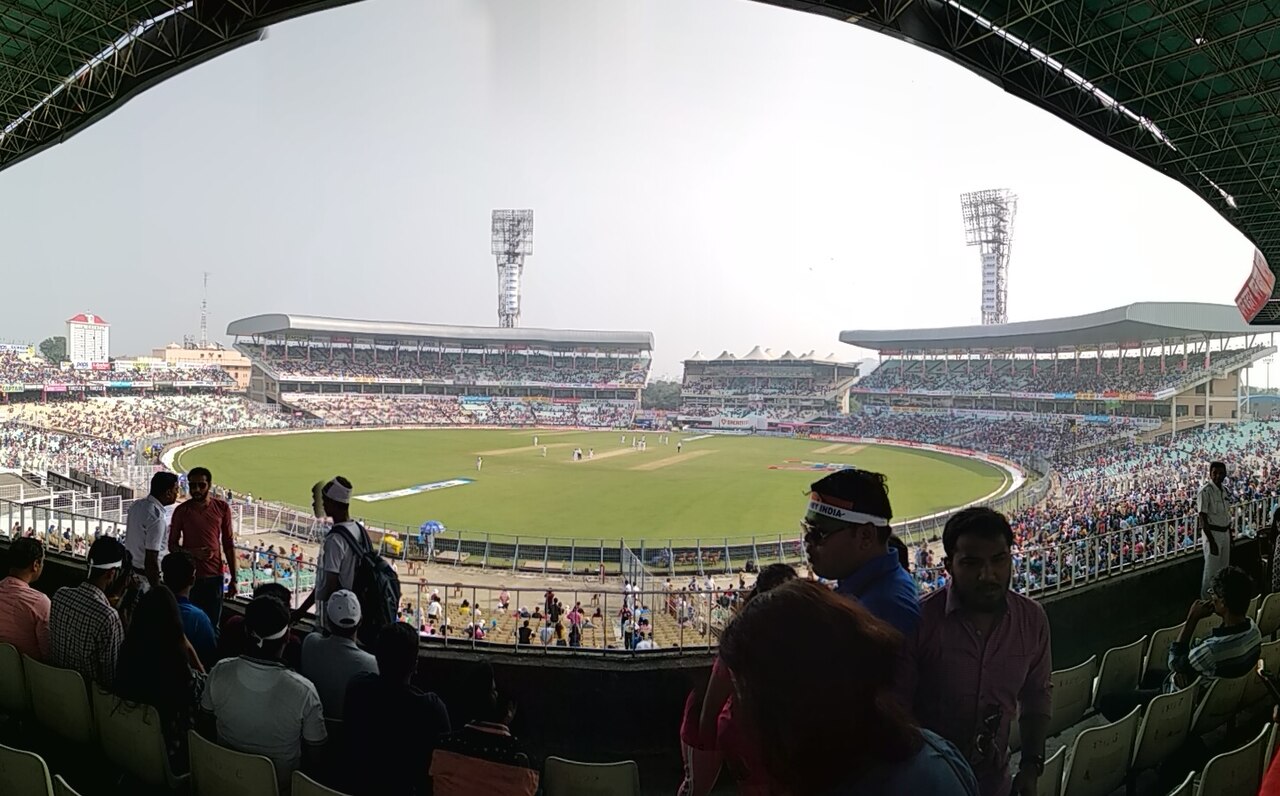 Floodlit cricket ground filling up ahead of an evening match in Kolkata